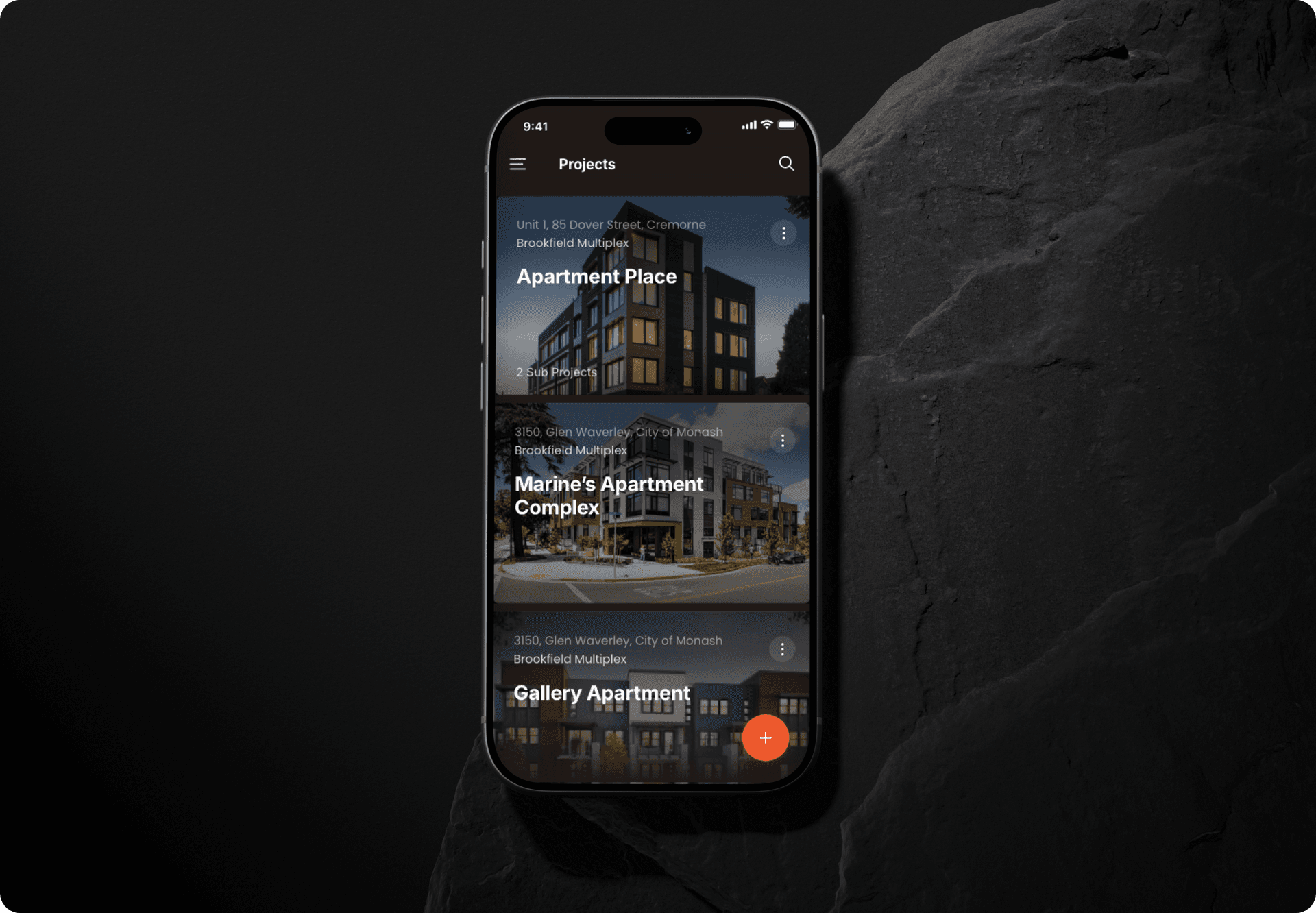 Carell mobile app — Projects screen showing Apartment Place, Marine's Apartment Complex, and Gallery Apartment on iPhone, set against a stone slab background